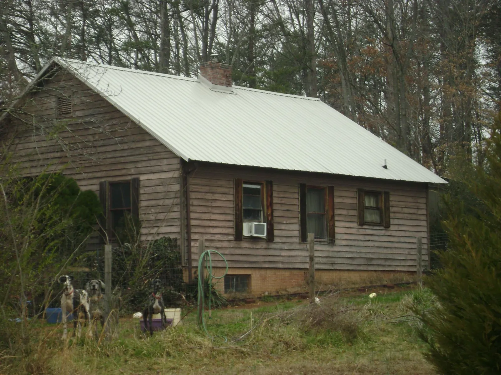 White metal roof on an old wood sided farmhouse, from a Asphalt Shingle Roof Repair job in Chapman